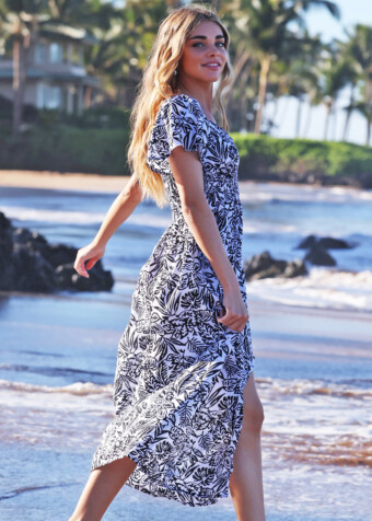 Form fitting ruched bodice with off shoulder sleeves. Front slit in midi length tropical dress